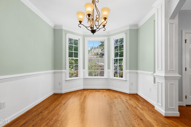 104 Shady Ridge Ct, Apex, NC 27502 - unfurnished dining area with wood finished floors, a chandelier, healthy amount of natural light, ornamental molding, and baseboards