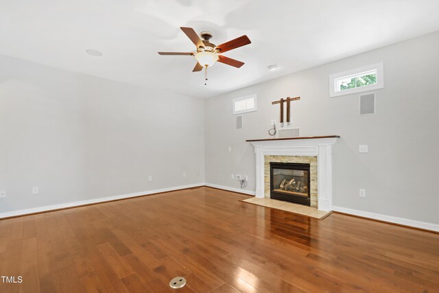 104 Shady Ridge Ct, Apex, NC 27502 - unfurnished living room featuring a ceiling fan, a fireplace, wood finished floors, and baseboards
