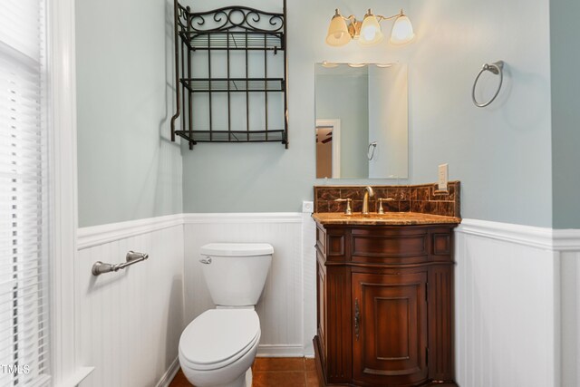 104 Shady Ridge Ct, Apex, NC 27502 - half bath featuring wainscoting, toilet, vanity, and tile patterned flooring