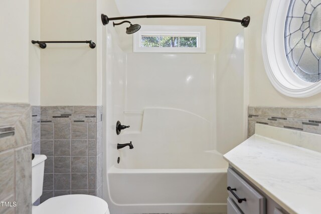 104 Shady Ridge Ct, Apex, NC 27502 - full bath featuring tile walls, vanity, toilet, tub / shower combination, and a wainscoted wall