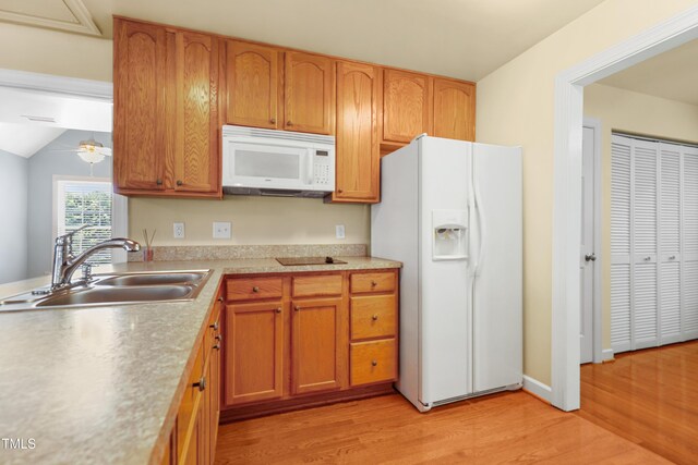104 Shady Ridge Ct, Apex, NC 27502 - kitchen featuring white appliances, a sink, light wood-type flooring, light countertops, and brown cabinetry