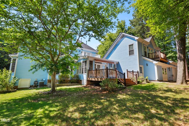 104 Shady Ridge Ct, Apex, NC 27502 - back of property with a sunroom, a lawn, a balcony, and a deck