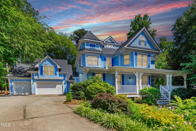 104 Shady Ridge Ct, Apex, NC 27502 - victorian house with driveway, a porch, and a garage