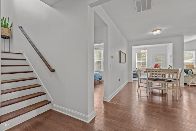3032 Curling Creek Dr, Apex, NC 27502 - dining area featuring dark wood-type flooring, plenty of natural light, and stairs