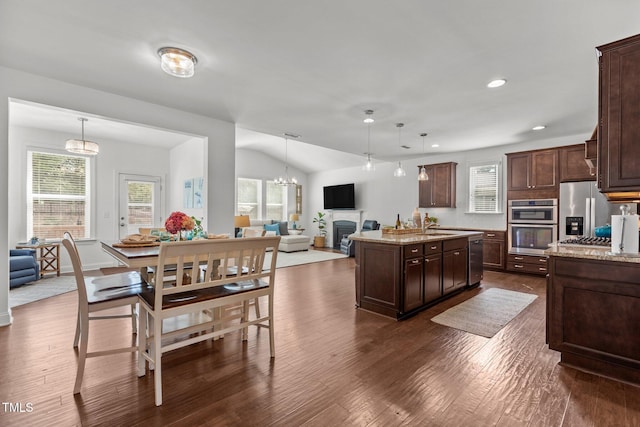 3032 Curling Creek Dr, Apex, NC 27502 - kitchen with appliances with stainless steel finishes, dark brown cabinetry, open floor plan, dark wood-style floors, and plenty of natural light