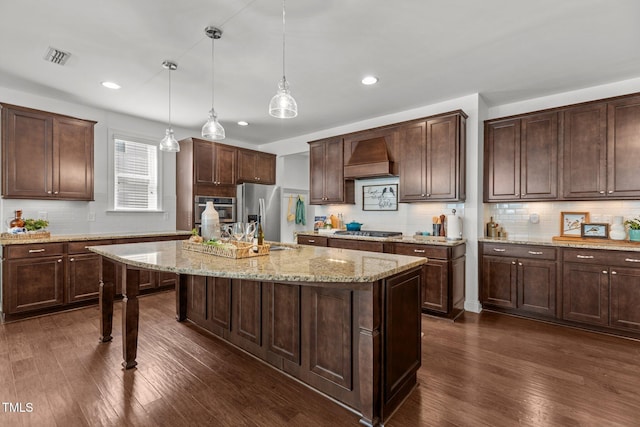 3032 Curling Creek Dr, Apex, NC 27502 - kitchen featuring stainless steel appliances, dark wood-type flooring, tasteful backsplash, dark brown cabinetry, and hanging light fixtures