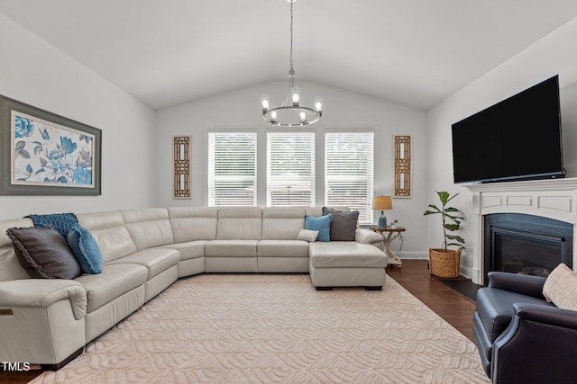 3032 Curling Creek Dr, Apex, NC 27502 - living area with a chandelier, wood finished floors, vaulted ceiling, and a glass covered fireplace