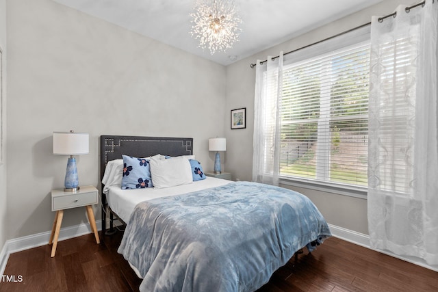 3032 Curling Creek Dr, Apex, NC 27502 - bedroom with wood finished floors, multiple windows, and a chandelier
