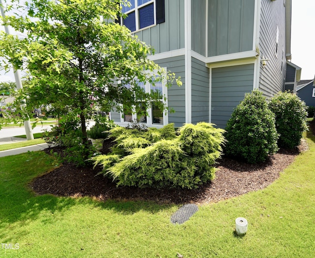 421 Old Ride Dr, Holly Springs, NC 27540 - view of side of property with board and batten siding and a lawn