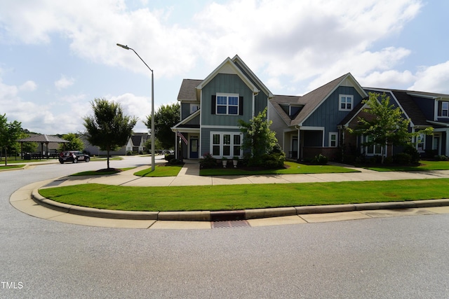 421 Old Ride Dr, Holly Springs, NC 27540 - view of front of home featuring board and batten siding and a front yard