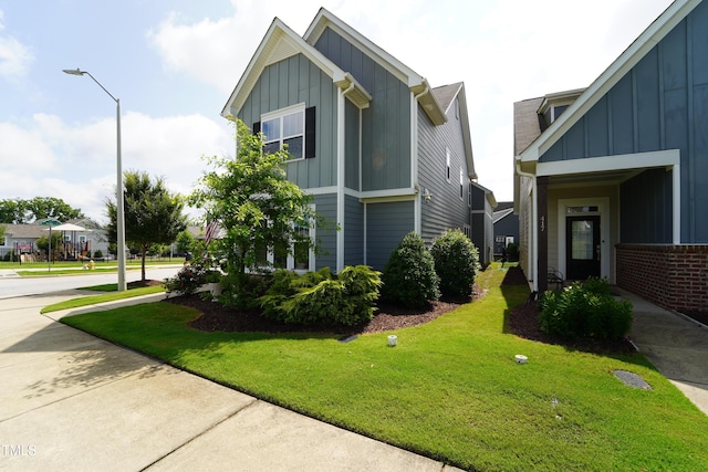 421 Old Ride Dr, Holly Springs, NC 27540 - view of home's exterior with board and batten siding and a lawn