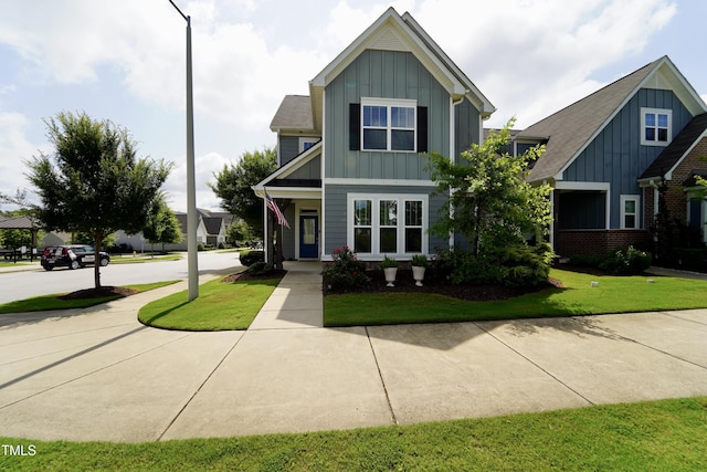 421 Old Ride Dr, Holly Springs, NC 27540 - view of front of home with board and batten siding and a front yard