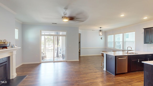 421 Old Ride Dr, Holly Springs, NC 27540 - kitchen with stainless steel dishwasher, a sink, crown molding, healthy amount of natural light, and dark wood-style floors