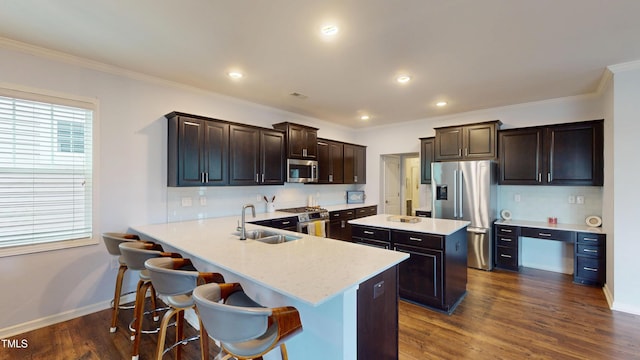 421 Old Ride Dr, Holly Springs, NC 27540 - kitchen featuring stainless steel appliances, a sink, a kitchen island, dark brown cabinetry, and dark wood-style floors
