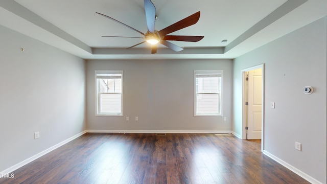 421 Old Ride Dr, Holly Springs, NC 27540 - spare room with a raised ceiling, a ceiling fan, healthy amount of natural light, and dark wood-type flooring