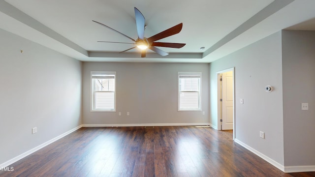 421 Old Ride Dr, Holly Springs, NC 27540 - spare room with ceiling fan, a raised ceiling, dark wood-style flooring, and baseboards