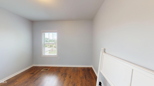 421 Old Ride Dr, Holly Springs, NC 27540 - spare room with baseboards and dark wood-type flooring