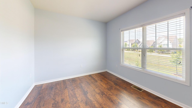 421 Old Ride Dr, Holly Springs, NC 27540 - empty room featuring plenty of natural light, baseboards, and dark wood-style floors