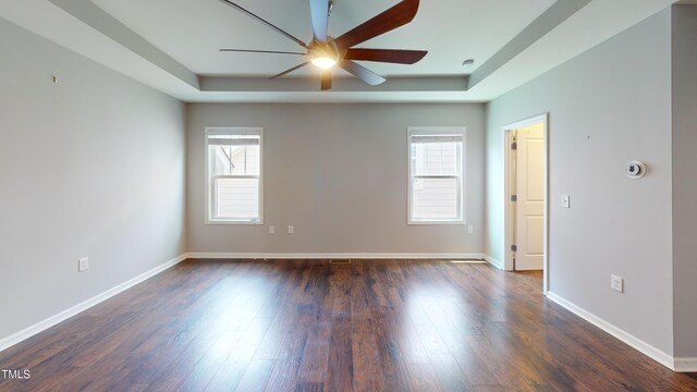 421 Old Ride Dr, Holly Springs, NC 27540 - spare room featuring a tray ceiling, a ceiling fan, plenty of natural light, and dark wood-style floors