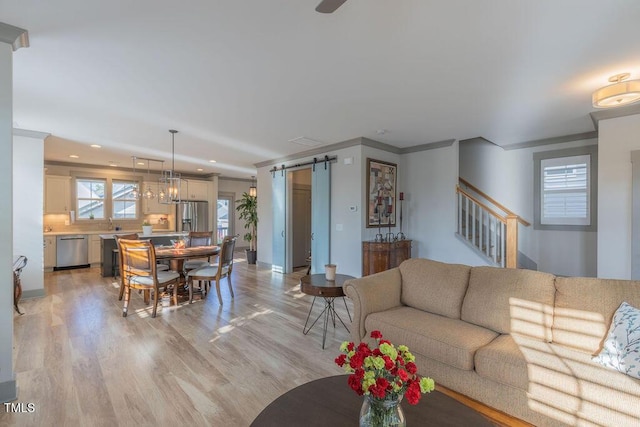 1624 Tunnel St, Wendell, NC 27591 - living room with a barn door, light wood-type flooring, stairway, recessed lighting, and crown molding