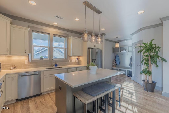 1624 Tunnel St, Wendell, NC 27591 - kitchen with appliances with stainless steel finishes, decorative backsplash, light countertops, a kitchen island, and recessed lighting