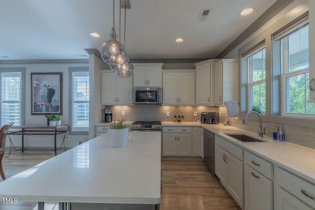 1624 Tunnel St, Wendell, NC 27591 - kitchen with appliances with stainless steel finishes, light countertops, white cabinetry, and recessed lighting