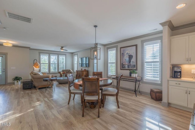 1624 Tunnel St, Wendell, NC 27591 - dining area featuring ornamental molding, light wood finished floors, healthy amount of natural light, and a ceiling fan