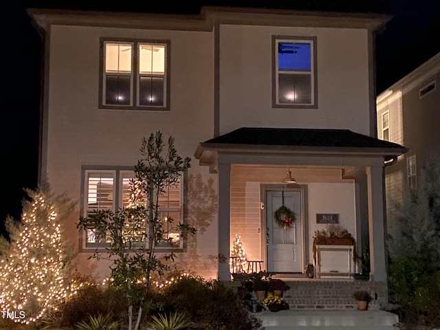 1624 Tunnel St, Wendell, NC 27591 - exterior entry at night featuring a porch and stucco siding