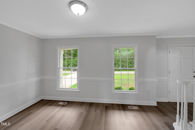 248 Robin Loop, Dunn, NC 28334 - unfurnished room featuring healthy amount of natural light, wood finished floors, ornamental molding, baseboards, and a textured ceiling