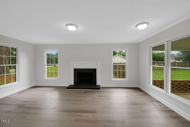 248 Robin Loop, Dunn, NC 28334 - unfurnished living room featuring wood finished floors, baseboards, a fireplace with raised hearth, and ornamental molding
