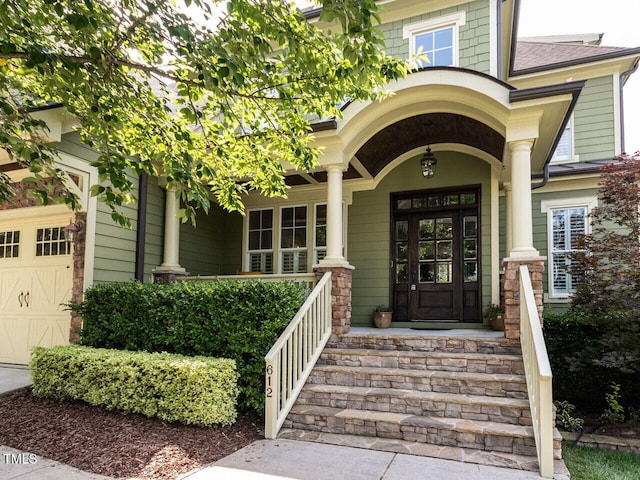 612 Peach Orchard Pl, Cary, NC 27519 - property entrance with a porch and a garage