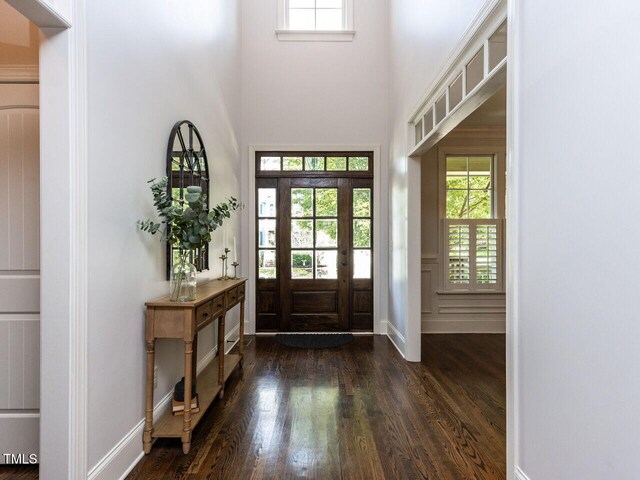 612 Peach Orchard Pl, Cary, NC 27519 - foyer with dark wood finished floors, plenty of natural light, a high ceiling, and baseboards