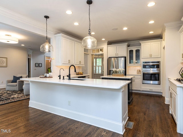 612 Peach Orchard Pl, Cary, NC 27519 - kitchen with appliances with stainless steel finishes, a peninsula, a sink, recessed lighting, and tasteful backsplash