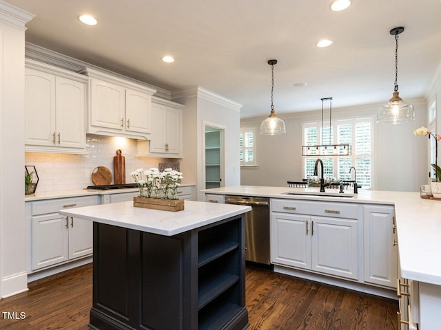 612 Peach Orchard Pl, Cary, NC 27519 - kitchen with appliances with stainless steel finishes, a sink, white cabinets, dark wood finished floors, and crown molding