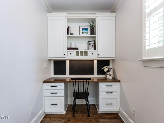 612 Peach Orchard Pl, Cary, NC 27519 - office area with built in desk, dark wood-style floors, crown molding, and baseboards