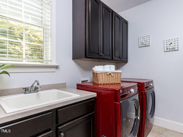 612 Peach Orchard Pl, Cary, NC 27519 - washroom with cabinet space, washing machine and dryer, light tile patterned floors, and baseboards