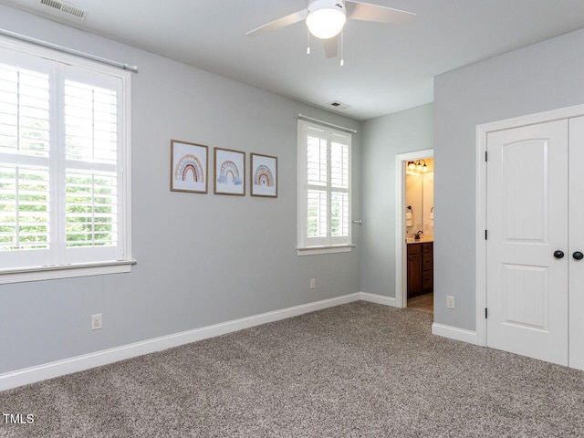 612 Peach Orchard Pl, Cary, NC 27519 - unfurnished bedroom featuring carpet, baseboards, ensuite bath, a closet, and a ceiling fan