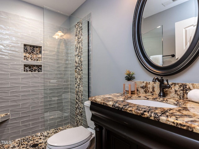 612 Peach Orchard Pl, Cary, NC 27519 - bathroom featuring a tile shower, toilet, and vanity