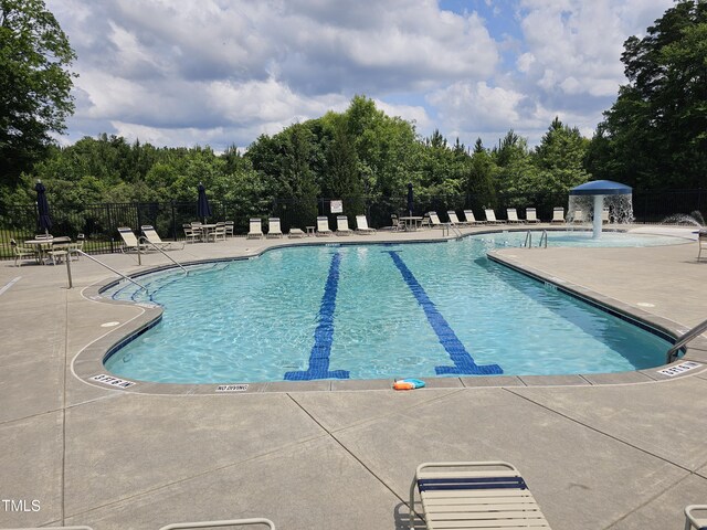 612 Peach Orchard Pl, Cary, NC 27519 - community pool with a patio and view of wooded area