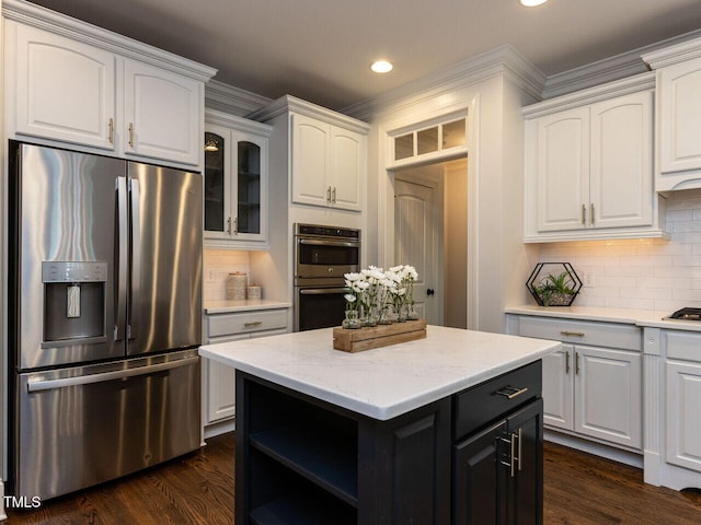 612 Peach Orchard Pl, Cary, NC 27519 - kitchen with stainless steel appliances, white cabinetry, crown molding, decorative backsplash, and glass insert cabinets