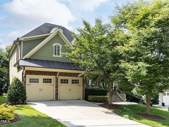 612 Peach Orchard Pl, Cary, NC 27519 - view of front facade featuring driveway, an attached garage, a standing seam roof, a front yard, and roof with shingles