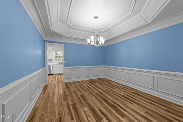 2913 Coxindale Dr, Raleigh, NC 27615 - unfurnished room featuring a chandelier, ornamental molding, a wainscoted wall, wood finished floors, and a tray ceiling