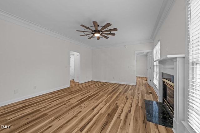 2913 Coxindale Dr, Raleigh, NC 27615 - unfurnished living room featuring ornamental molding, a fireplace, a ceiling fan, and light wood-type flooring