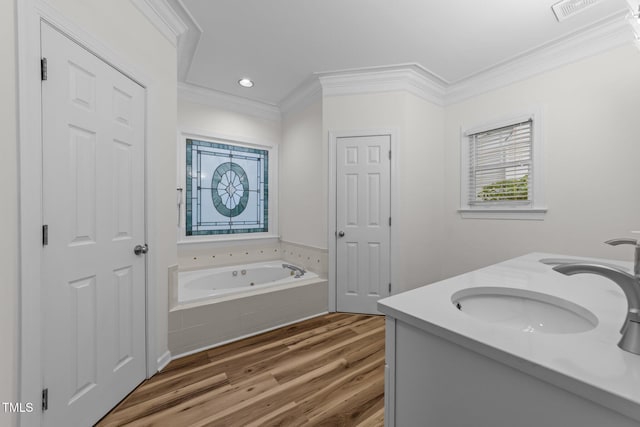 2913 Coxindale Dr, Raleigh, NC 27615 - bathroom with crown molding, a jetted tub, wood finished floors, double vanity, and recessed lighting
