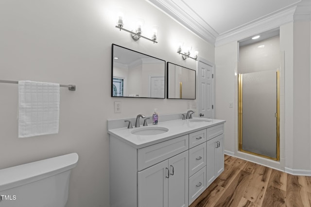 2913 Coxindale Dr, Raleigh, NC 27615 - full bathroom featuring crown molding, double vanity, a stall shower, and wood finished floors