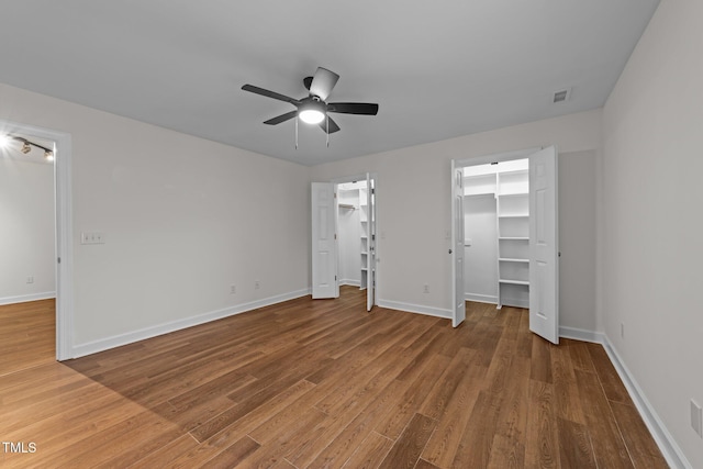 2913 Coxindale Dr, Raleigh, NC 27615 - unfurnished bedroom with wood finished floors and a ceiling fan