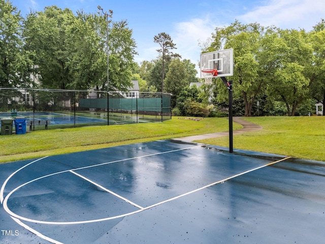 2913 Coxindale Dr, Raleigh, NC 27615 - view of basketball court with basketball hoop, a tennis court, and view of wooded area