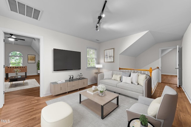 2913 Coxindale Dr, Raleigh, NC 27615 - living area featuring light wood finished floors, a ceiling fan, lofted ceiling, and rail lighting
