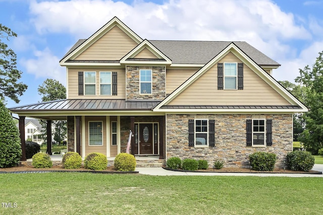 513 Goal Kick, Fuquay Varina, NC 27526 - craftsman house featuring a standing seam roof, a front yard, covered porch, stone siding, and a metal roof