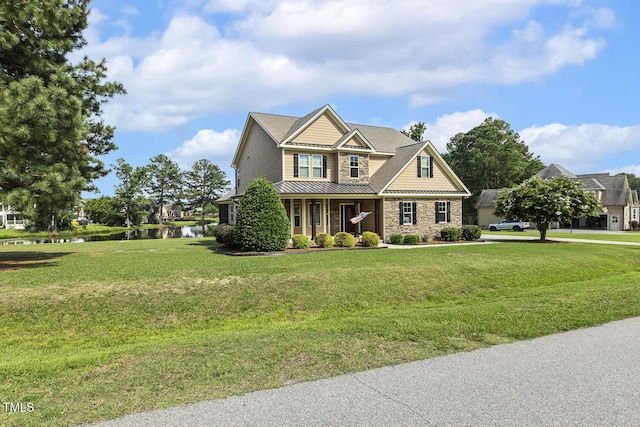 513 Goal Kick, Fuquay Varina, NC 27526 - craftsman-style house with a water view, stone siding, a front yard, a standing seam roof, and a metal roof